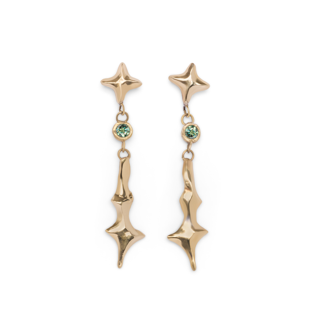 A pair of Madeleine Blaine Nova Earrings Small with Moissanite featuring star-shaped studs, lustrous green gemstone accents, and abstract, wavy gold dangles—these showstopping earrings will add a radiant finishing touch to any look.