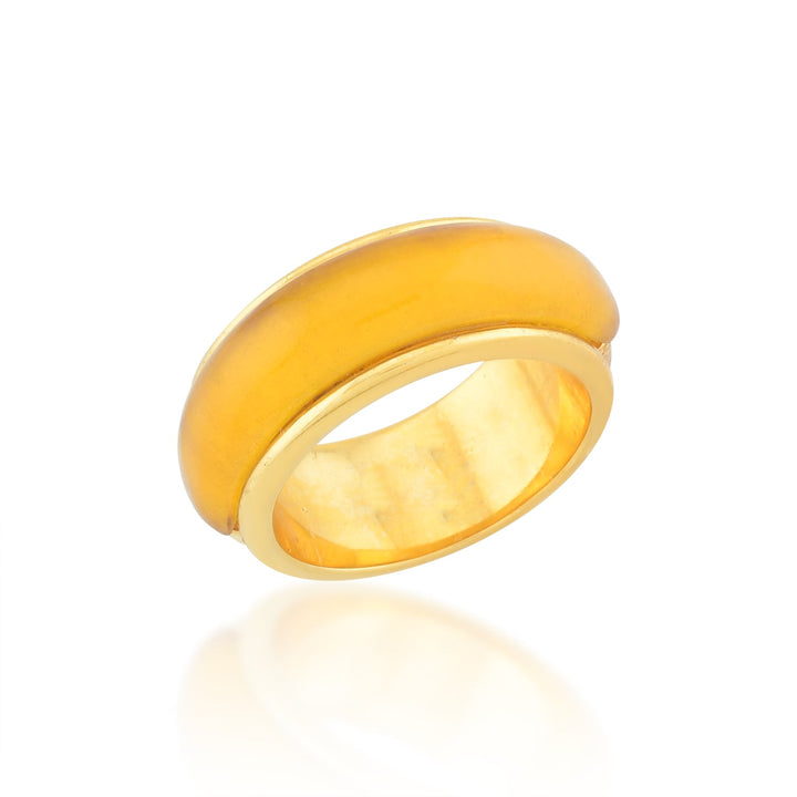 A polished, golden-yellow translucent ring with a smooth, curved outer surface and a glossy finish is shown on a white background with a slight shadow beneath it. This chunky Orion Ring from Shyla is part of our hypoallergenic jewellery collection, perfect for those seeking style without compromise.