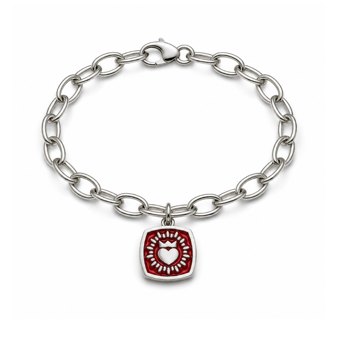 Introducing the Double Sided Keith Haring Claddagh On Charm Bracelet from The Collective Dublin: this sterling silver bracelet features a sleek silver chain adorned with a double-sided, red square-shaped charm showcasing Keith Haring's iconic white heart design at its center—a contemporary interpretation of classic Irish jewelry.