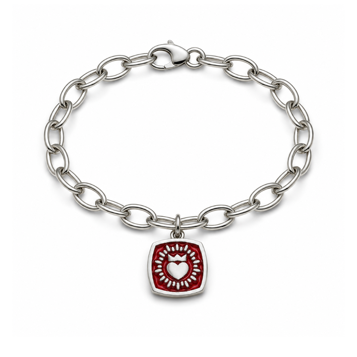 Introducing the Double Sided Keith Haring Claddagh On Charm Bracelet from The Collective Dublin: this sterling silver bracelet features a sleek silver chain adorned with a double-sided, red square-shaped charm showcasing Keith Haring's iconic white heart design at its center—a contemporary interpretation of classic Irish jewelry.