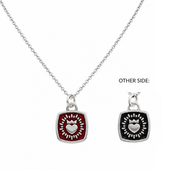 Discover The Collective Dublin's Double Sided Keith Haring Pendant with Chain—a silver necklace featuring a square pendant adorned with a heart encircled by radiant rays, echoing iconic Keith Haring artistry. The pendant showcases red on one side and black on the other, as illustrated beside the necklace under the label "OTHER SIDE.