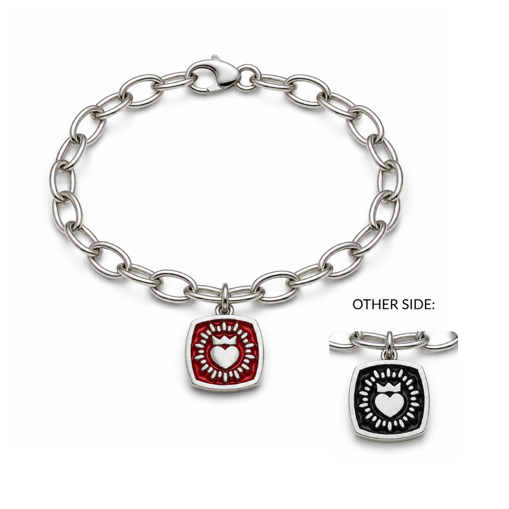 Double Sided Keith Haring Claddagh On Charm Bracelet by The Collective Dublin features a silver chain with a square charm displaying a white heart within a red border; the reverse side shows the same heart design against a black background. This contemporary piece creatively reinterprets traditional Irish jewelry with iconic Keith Haring motifs.