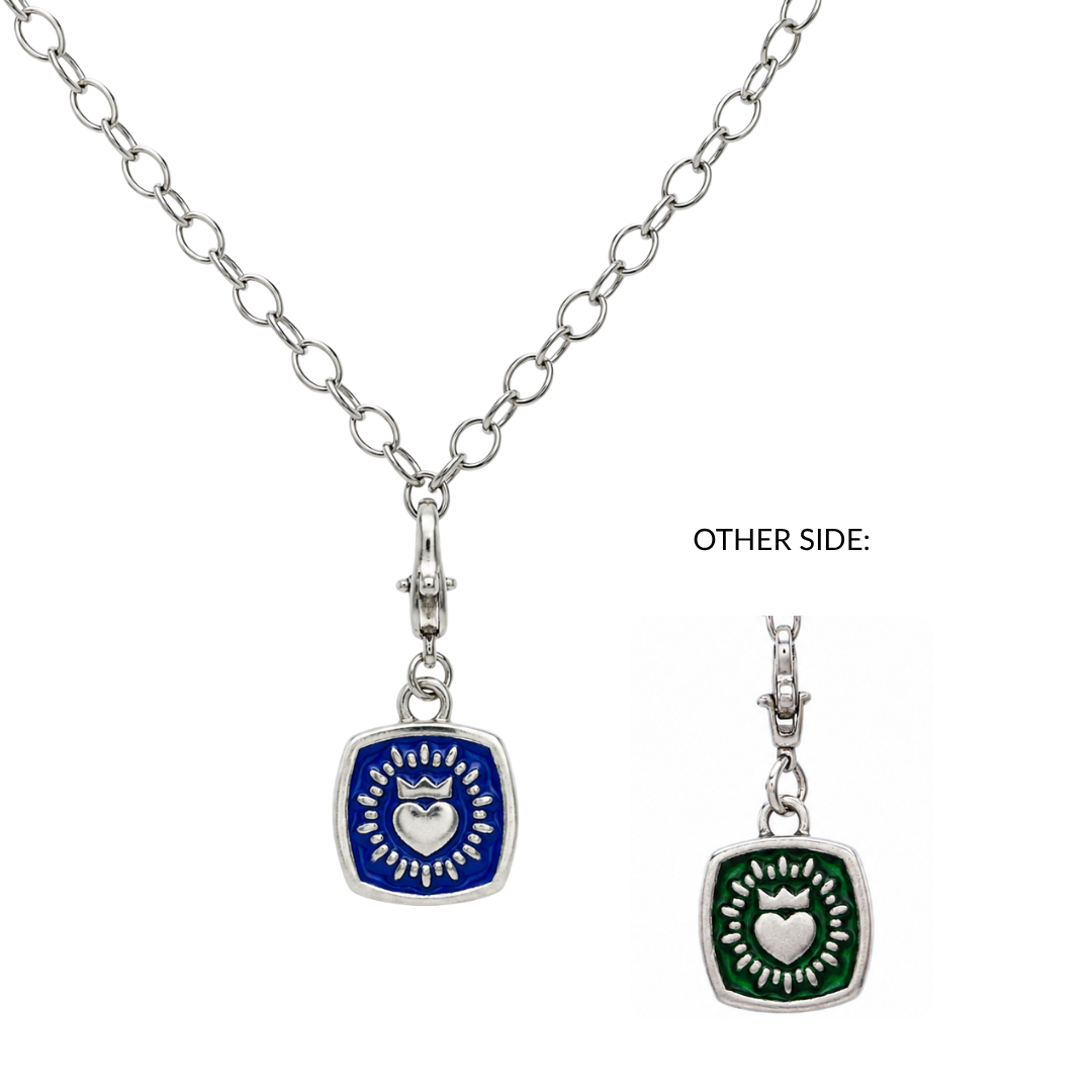 Introducing the Double Sided Keith Haring Pendant with Chunky Chain by The Collective Dublin: this unique sterling silver necklace features a square charm—one side is blue with a sun and crown, the other green with a sun and heart. Sun ray motifs surround each symbol, blending contemporary Keith Haring-inspired artistry with traditional Irish jewelry influences for a standout piece from The Collective Dublin.