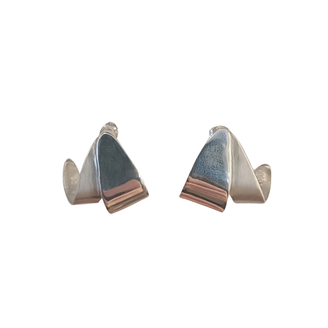 Discover the Origata Studs by Gallardo & Blaine Designs: sterling silver earrings featuring angular abstract shapes and a shiny folded design, embodying a modern, minimalist aesthetic ideal for any sophisticated collection.