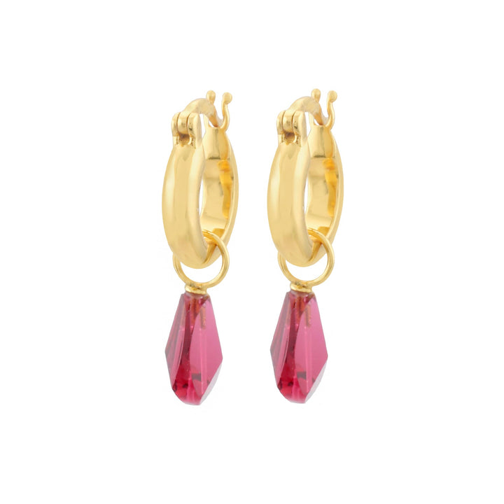 A pair of Shyla Priya Earrings featuring eye-catching pink gemstone pendants. The gold on sterling silver hoops have a smooth polished finish, and the hypoallergenic pink gemstones are faceted in a teardrop shape, hanging delicately from the hoops.