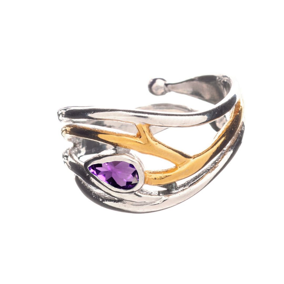 Discover Gallardo & Blaine Designs' Peacock Ring, featuring a stunning silver and gold-toned intertwined design with a purple tear-shaped gemstone set in gold vermeil. Its polished finish and open-ended band make it an exquisite statement piece.