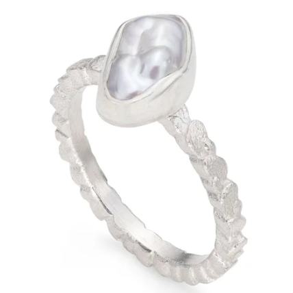 Silver ring with a textured band with a irregular baroque keshi pearl on a white background