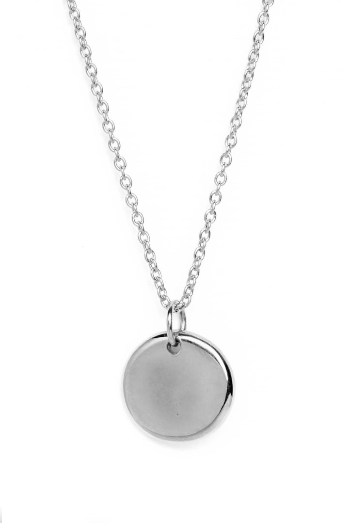 A sterling silver necklace with a round organic shaped circle pendant measuring 15mm in diameter which has a subtle indent in the centre.