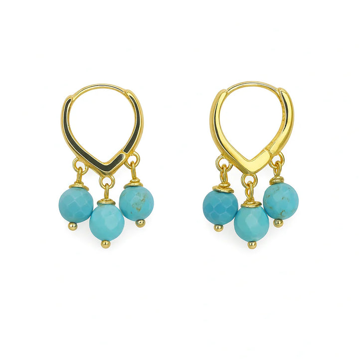 Polly Earrings by Aria V: Gold-plated hoops with three dangling turquoise beads on each, showcased on a white background. Handmade in Ireland, these vibrant earrings add a pop of color to any outfit.