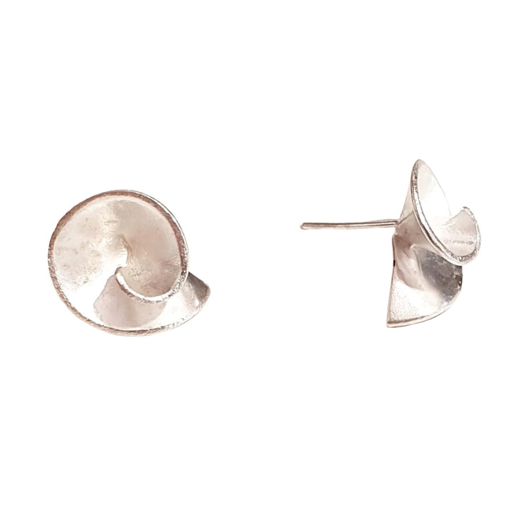 A pair of Small Swirl Earrings designed by Georgia Charal with an artistic, spiral shape. The polished metallic surface gives them a shiny appearance against a plain white background.