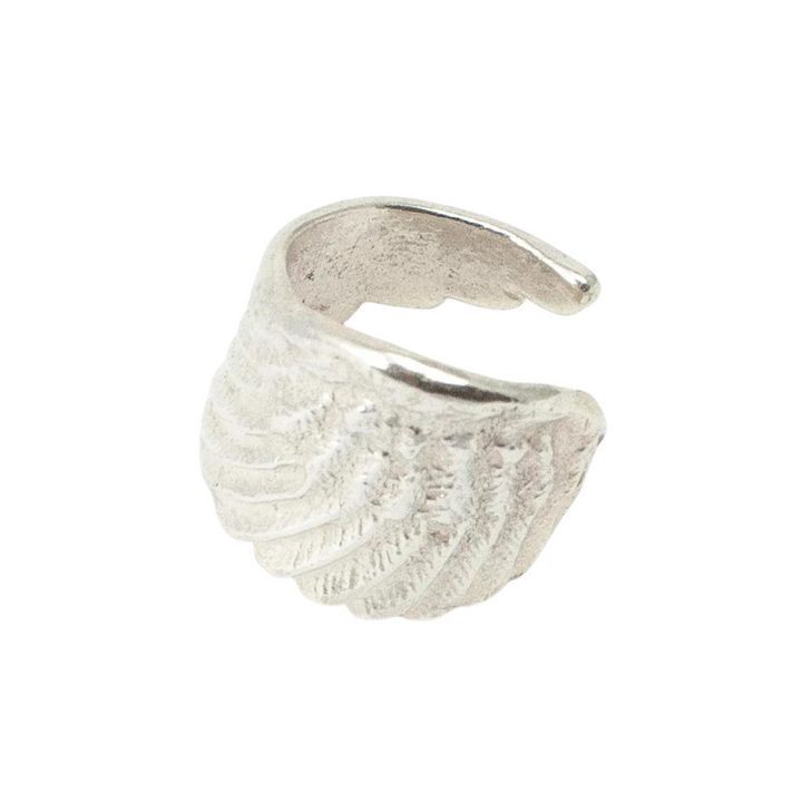 The Angel Wing Ring by Jennifer Kinnear (in silver or gold) features a textured, wing-inspired design. Its adjustable, open-ended band ensures a comfortable fit and easy wear.
