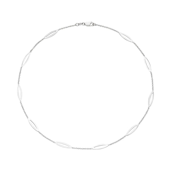 The Tezer Leaf Chain Necklace features a delicate sterling silver design with an evenly spaced oval link pattern along a slender chain, displayed in a circular arrangement against a white background.
