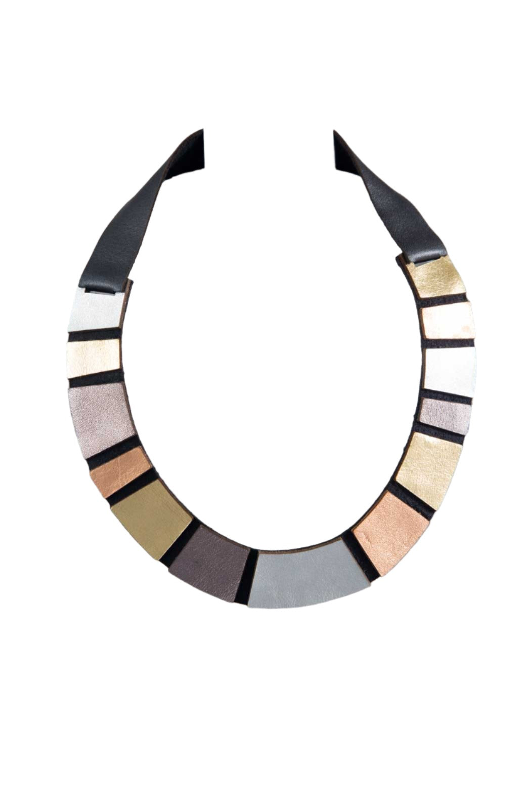 The Rainbow Leather Metallics Necklace by Iskin Sisters is showcased against a textured, white, checkered background. This geometric necklace features an array of rectangular segments in metallic shades of silver, gold, bronze, and black, all elegantly attached to an Argentinian leather strap.