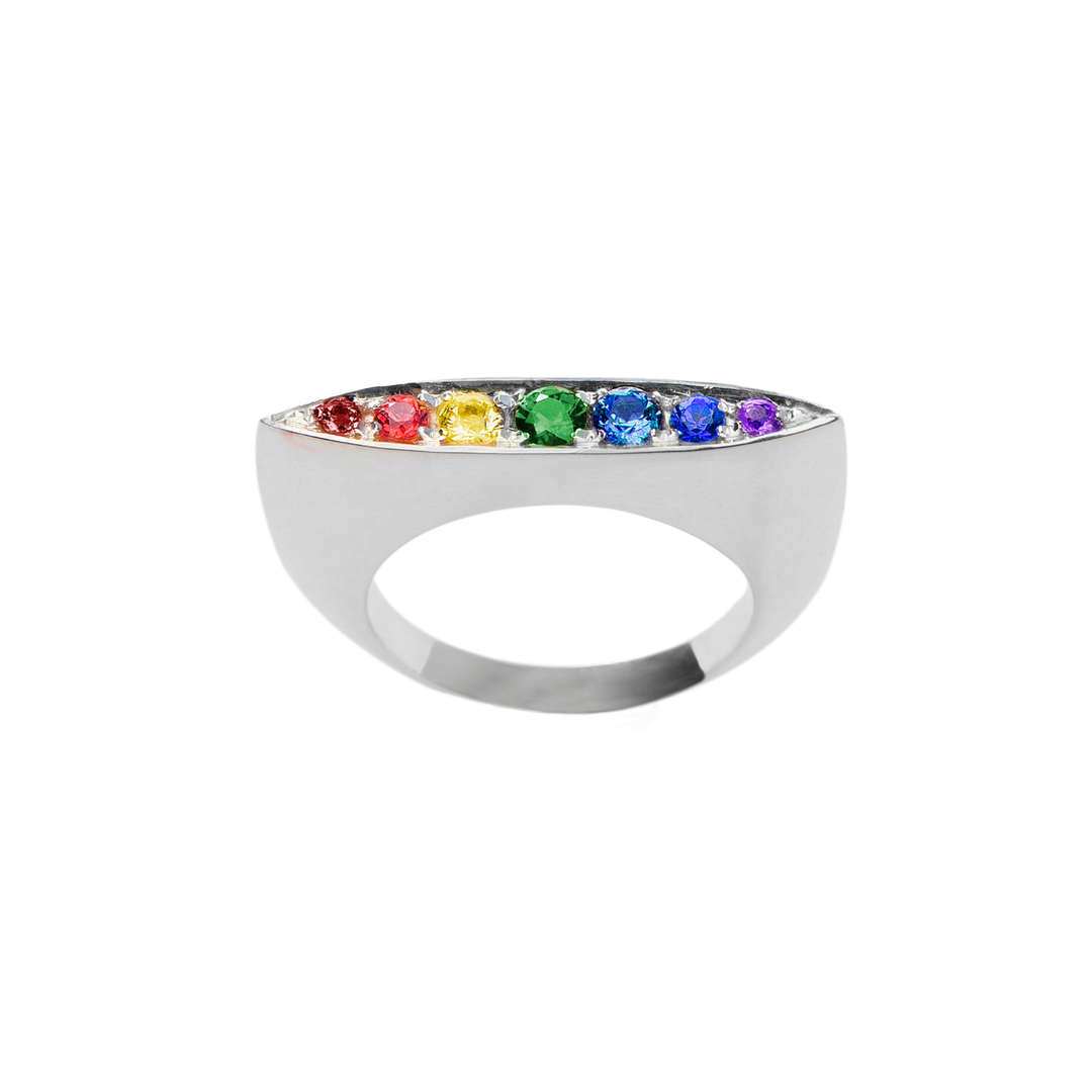 The Rainbow Star Ring by Cosmic Boulevard is crafted in sterling silver, showcasing seven vibrant gemstones—red, orange, yellow, green, blue, indigo, and violet—in a straight pavé row for a colorful statement look.