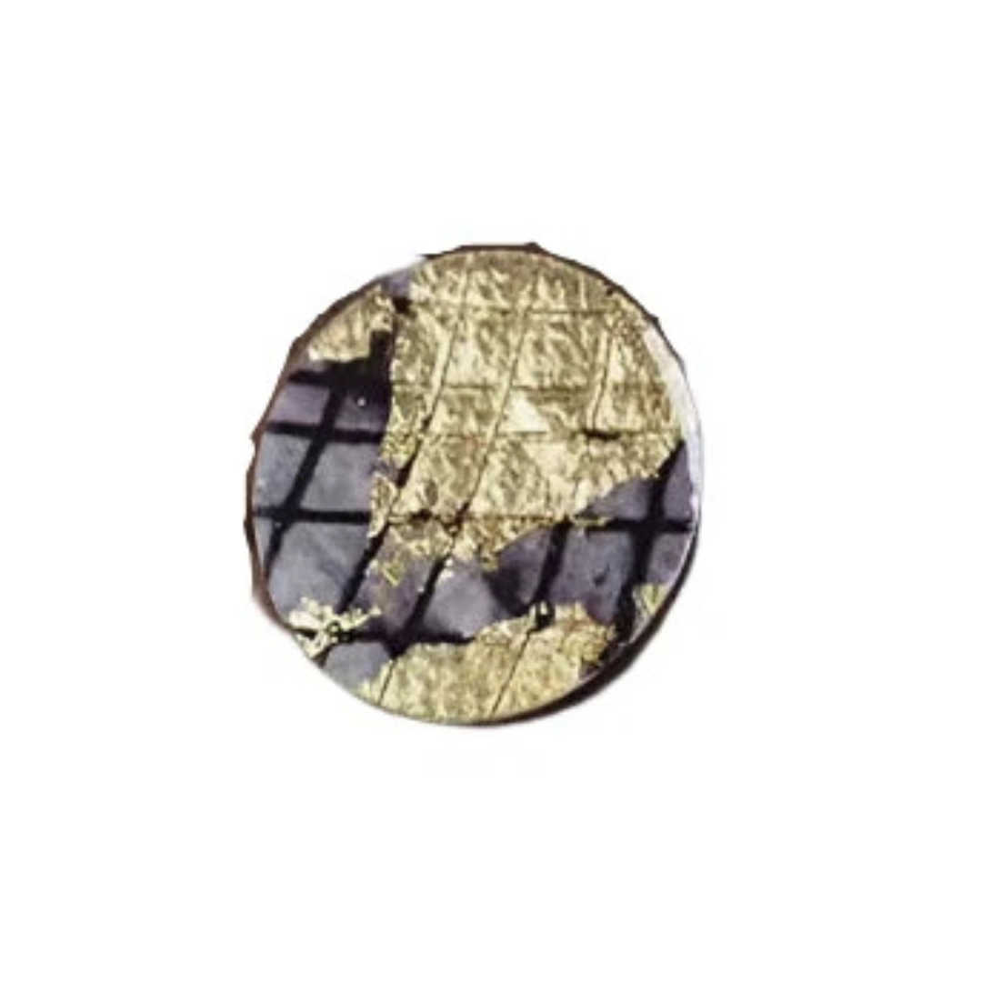 The Ró Cocktail Ring in Gold/Black by Rothlú features a small, round design with a textured gold sgraffito batik pattern over a dark, grid-like background, displayed on a white surface.