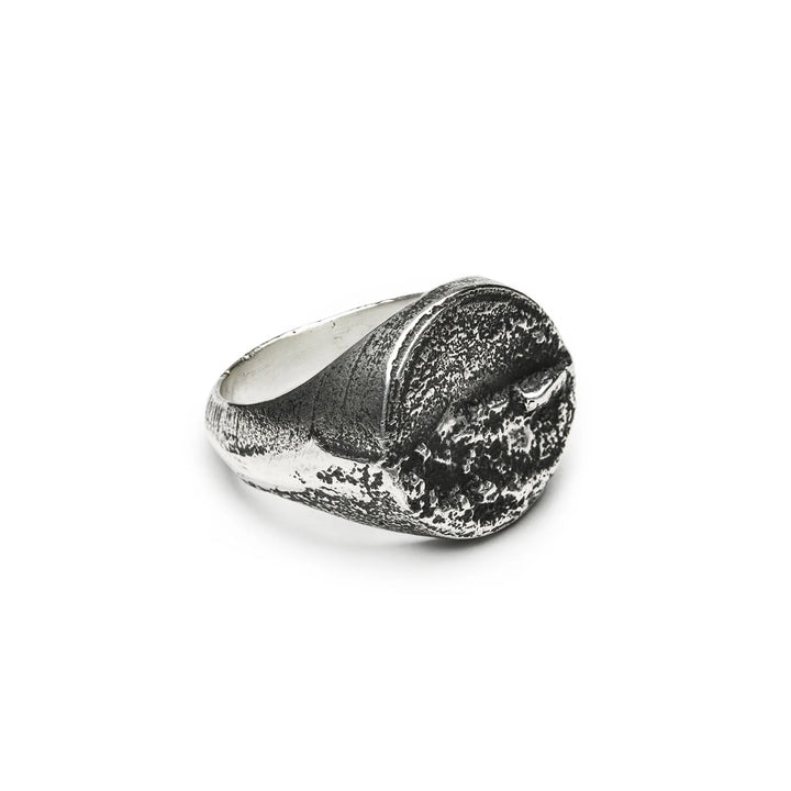 Introducing the Septentrion Round Signet Ring—a textured, handmade 925 silver piece featuring a wide band and a rugged, crater-like surface on top. This artisanal ring highlights expert craftsmanship and offers an organic, distinctive look.