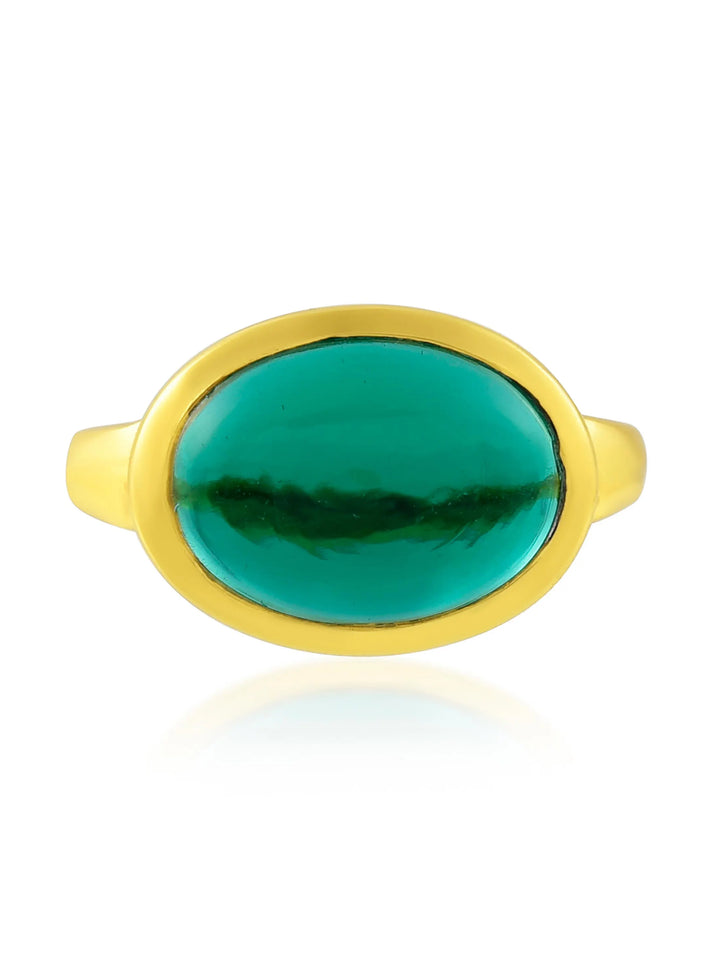 A Shyla Sian Gold Plated Ring crafted in 22 carat gold, featuring a large, oval-shaped green gemstone in the center. The gem is smooth and polished, set in a simple, sleek gold band. The image is taken against a plain white background.