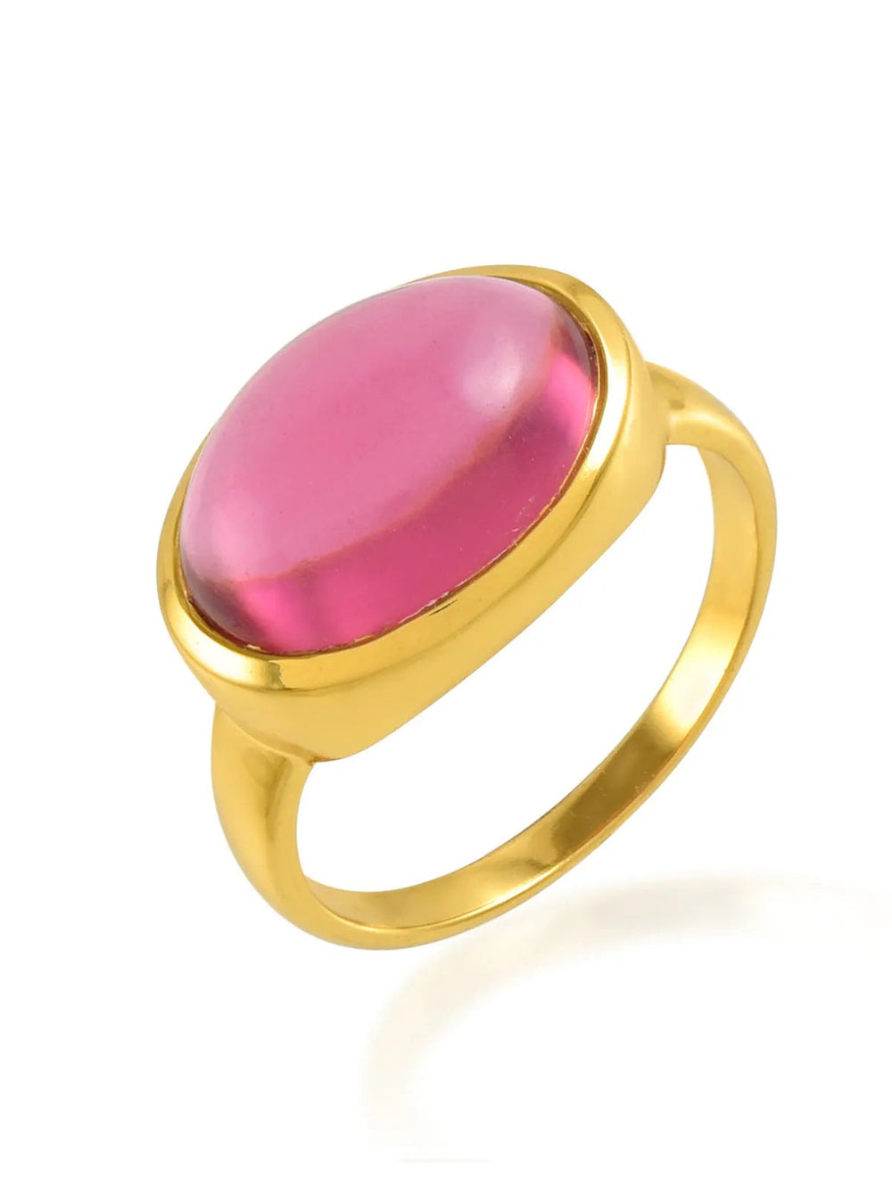 A gold ring with a large, oval-shaped, translucent pink stone is set in a simple, polished 22 carat gold band. The Sian Gold Plated Ring by Shyla is positioned at a slight angle, showcasing the smooth surface and vibrant color of the stone.