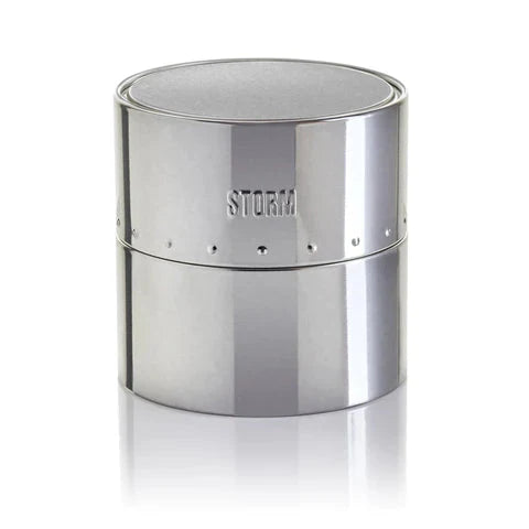 A sleek, reflective silver cylindrical container embossed with "STORM" on the upper half. It boasts a minimalist design with a subtle groove separating the top and bottom halves. Product: Storm Mini Sotec Lazer Green by Storm Watches.