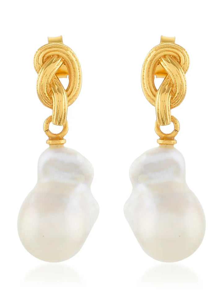 Synthea Earrings by Shyla in various colours, featuring gold knot design with dangling irregular-shaped white pearls. Elegant and hypoallergenic, they offer timeless style and comfort for sensitive ears, shown on a white background.
