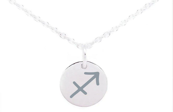 A Horoscope Large Disc Charm Silver by Personalised Charms features a round pendant with the Sagittarius zodiac sign, an arrow pointing diagonally upwards to the right. The chain is slightly twisted, and the image has a white background.