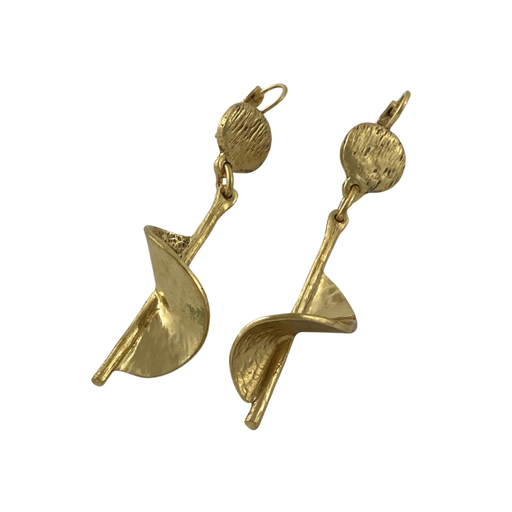 A pair of Sara Gold Plated Pewter Earrings from J. Boetsch Creations featuring a hammered circular top and a dangling abstract spiral design. The earrings have a textured finish and are attached to hooks for wearing.
