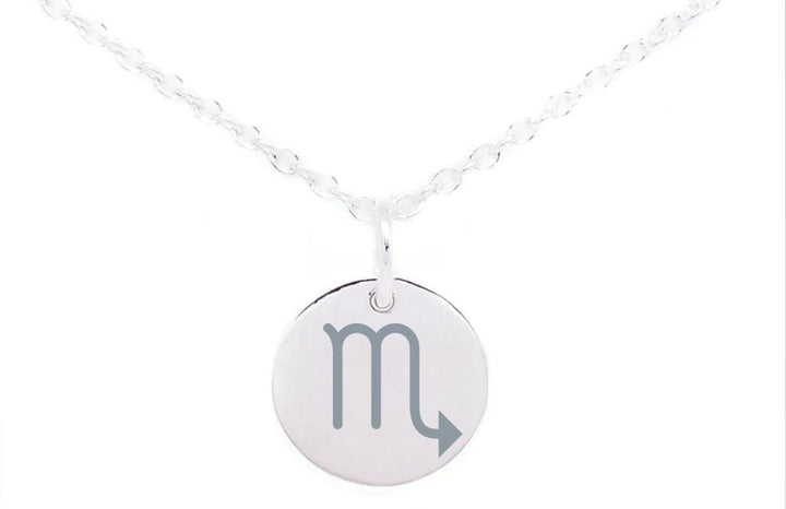 A sterling silver necklace with a thin chain features a round pendant adorned with the Scorpio zodiac sign, resembling a letter "M" with an arrow pointing upward and to the right. The background is plain white, making it a perfect piece for those who cherish horoscope symbols. This beautiful piece is called Horoscope Large Disc Charm Silver by Personalised Charms.