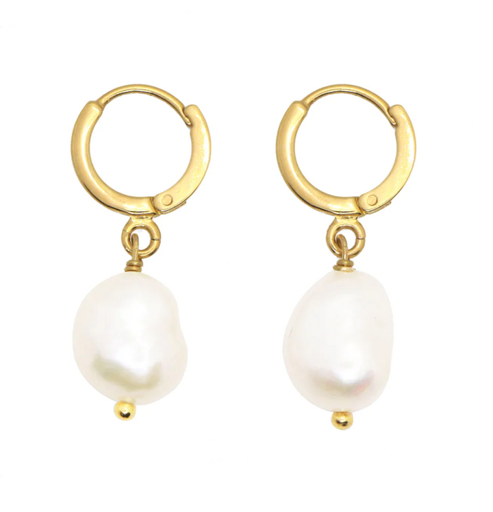 A pair of Mini Perla Earrings from Nilai, featuring dangling white freshwater pearls. The pearls are irregularly shaped, adding a unique and organic touch to the elegant design.