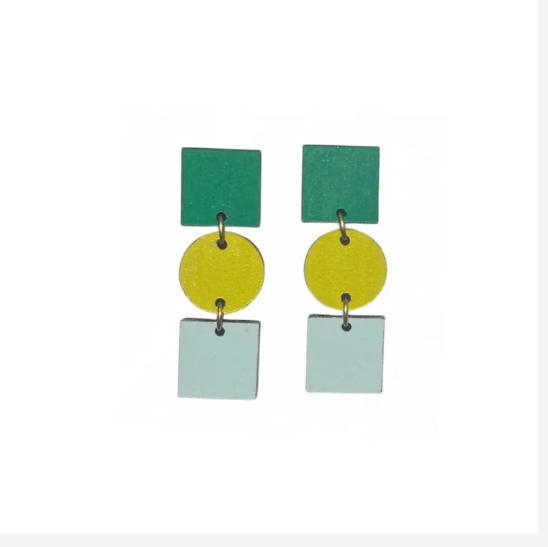 The Ruth Earrings in Emerald, Moss and Minty Grey by Shock of Grey are hand-painted birchwood drops with green, yellow, and light blue geometric shapes stacked vertically. Presented in a recycled gift box.