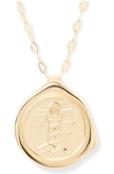 The My Guiding Light Pendant Gold by Ava Jane Jewellery is a meaningful keepsake, showcasing a lighthouse design with an embossed finish and uneven edge on an elegant oval link chain.
