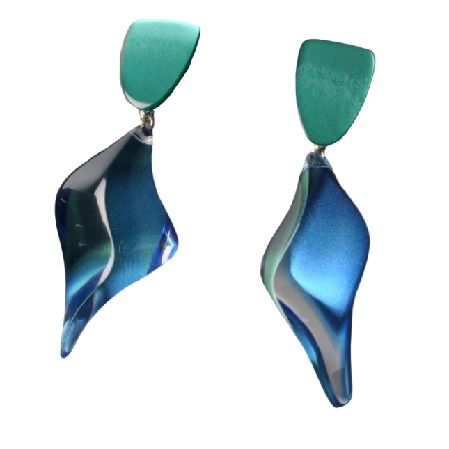 A computer screen shows a PDF with two handmade French earrings: orange acrylic drops on a branch with a desert background, and MX.design’s Acrylic Blue/Green Genie Earrings photographed against nature.