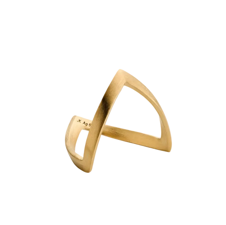 A contemporary V Ring by Jane Koenig featuring a geometric gold design with an open, asymmetrical shape, displayed on a simple light gray background.