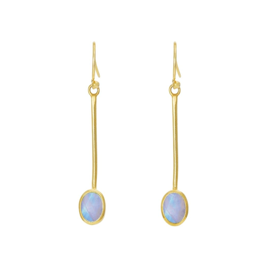 The Sequola Earrings by Gallardo & Blaine Designs feature two gold drop earrings with long, slender stems and iridescent oval gemstones reflecting blue and purple shades. They exude timeless charm and are equipped with simple hook attachments for wearing.