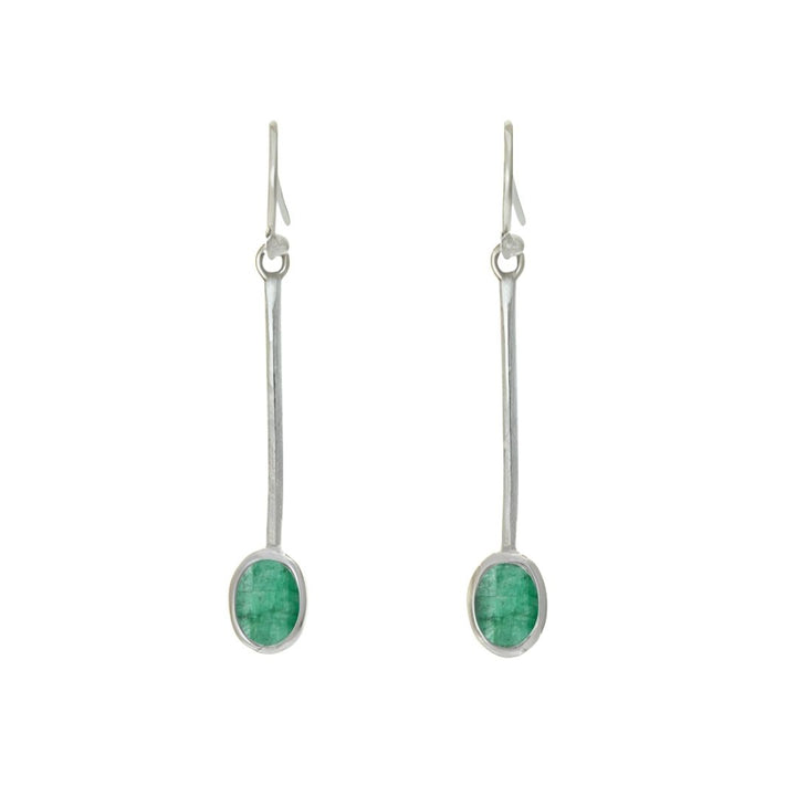 The Sequola Earrings by Gallardo & Blaine Designs feature two sterling silver drop earrings with long stems, each adorned with an oval green gemstone in sleek silver settings and fitted with hooks for wearing, offering a timeless charm through their simple yet elegant design.