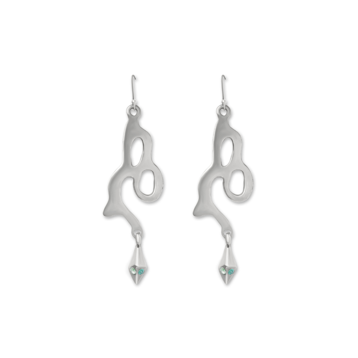 The Serpent Earrings by Madeleine Sculptural Jewellery are silver, abstract-shaped dangles with cut-out designs, pointed tips, and light blue gemstones—crafted sustainably for a stylish, eco-conscious statement.