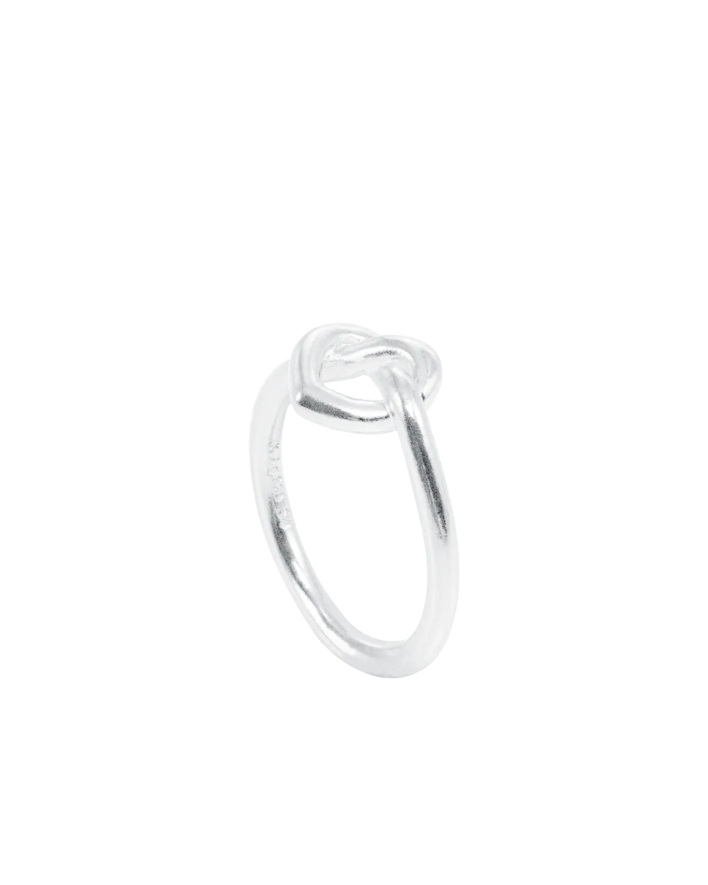 The Jane Koenig Tied Heart Ring is a sterling silver piece with a knot design, shown against a white background.
