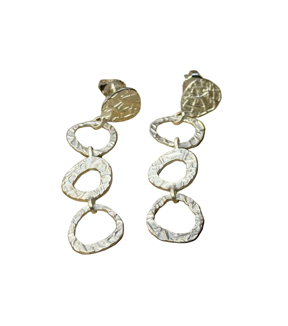 Tezer Silver Circular Dangle Stud Earrings feature three interlinked textured oval hoops and a round textured stud, shown on a white background.