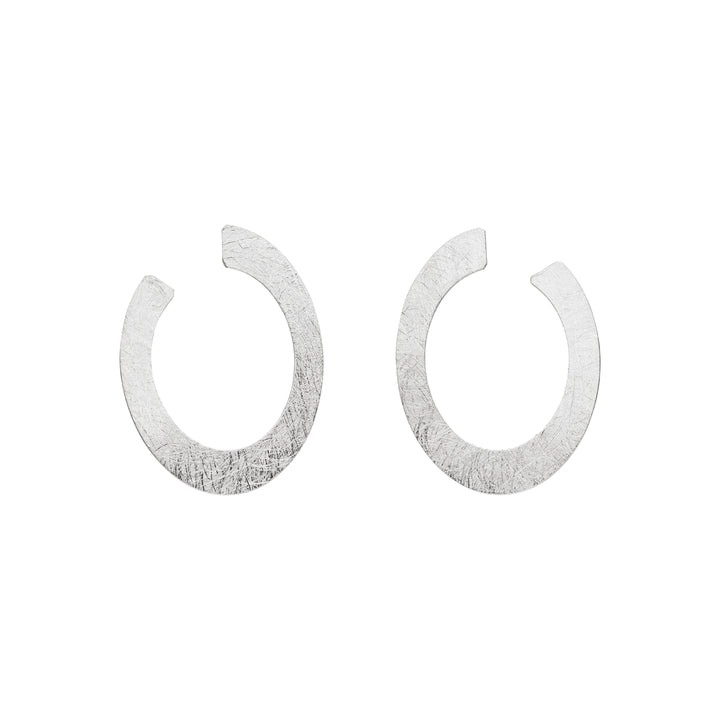 A pair of Tezer Open Oval Earrings crafted from textured sterling silver with a matte finish, shown on a plain white background.
