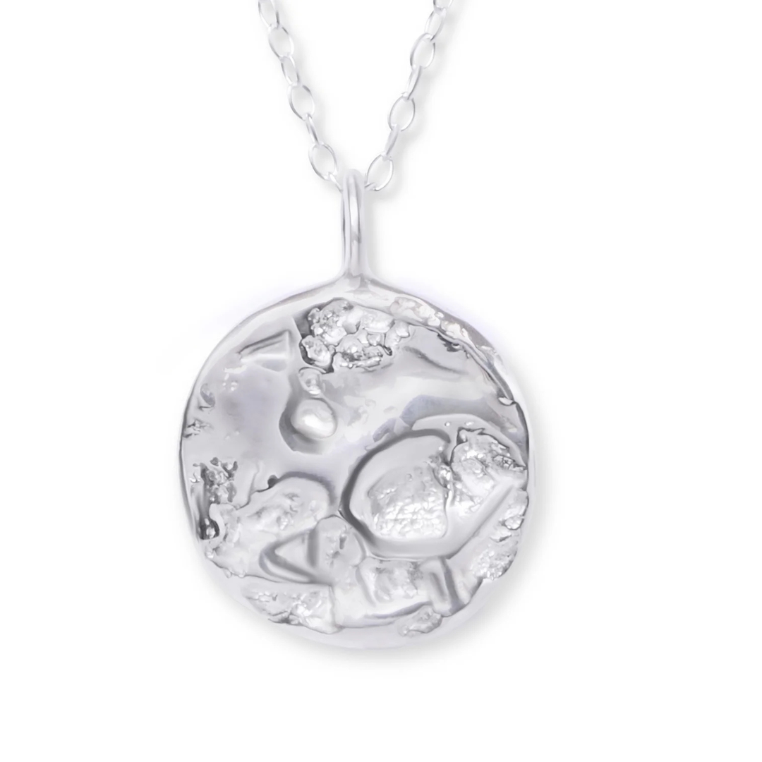 The Ava Jane Jewellery Dublin Bay Silver Pendant is a handmade sterling silver necklace with an abstract, textured circular design on a delicate chain.