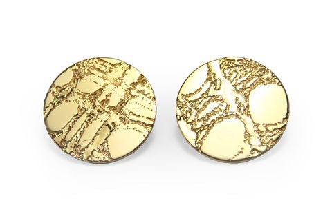 The Etched 'Skin' Stud Earrings by Sara Gunn in gold feature an organic, abstract pattern on their round surfaces. The texturing generates a slightly raised and uneven look, similar to embossed leather, resulting in a distinctive and artistic aesthetic against a plain white background.