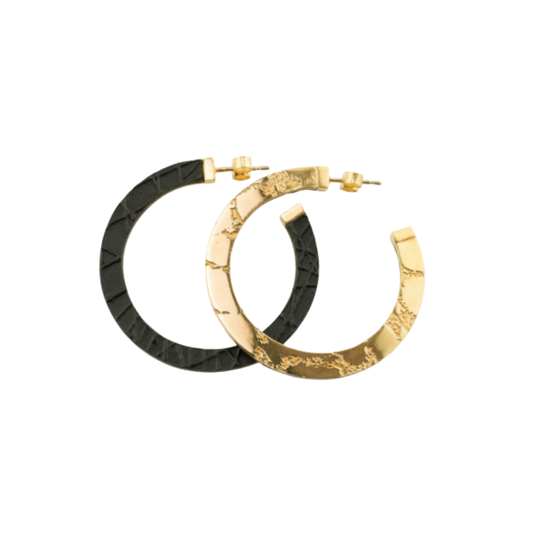 Two Skin Etched Hoop Earrings by Sara Gunn, available in silver or gold, overlap on a white background. These semi-circular hoops feature unique etched patterns and post back closures.