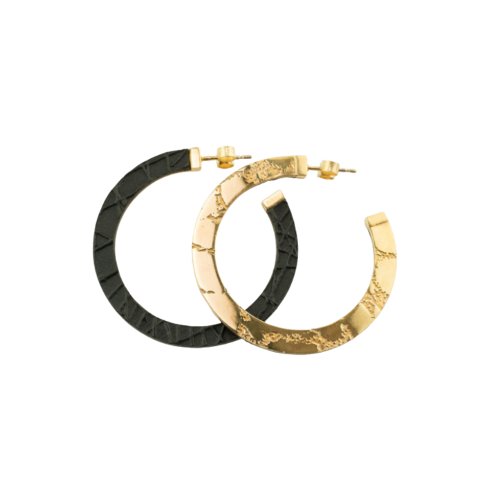 Two Skin Etched Hoop Earrings by Sara Gunn, available in silver or gold, overlap on a white background. These semi-circular hoops feature unique etched patterns and post back closures.