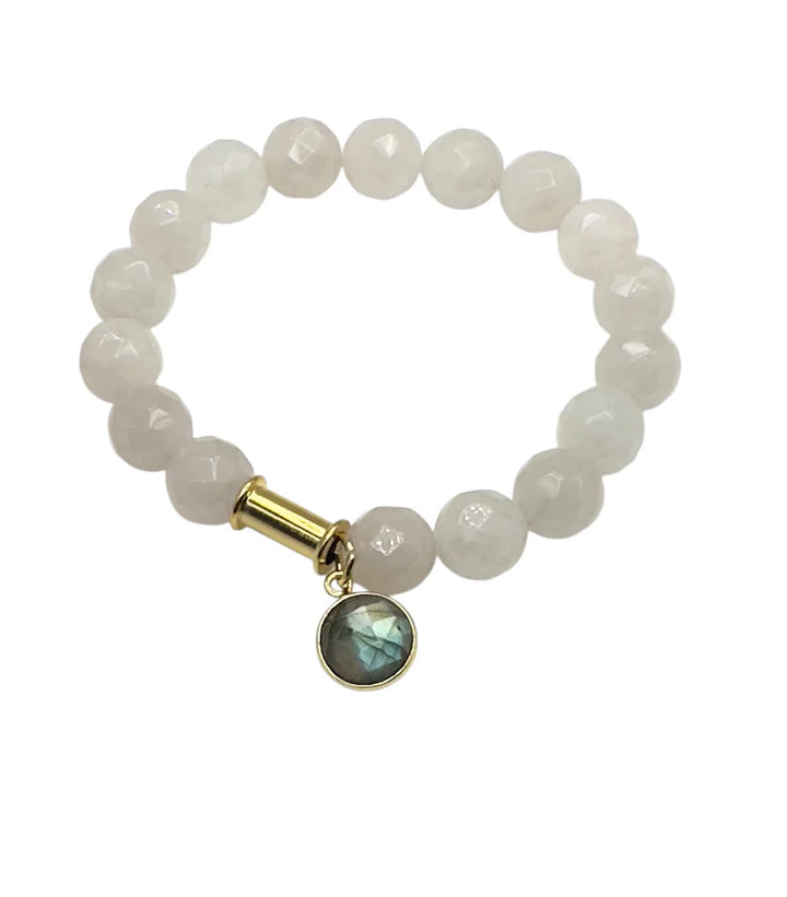 The Aria V Soulstone Rose Quartz and Labradorite Bracelet features white natural stone beads with a round faceted gemstone charm set in gold, hanging from a gold cylindrical bead, shown on a plain white background.