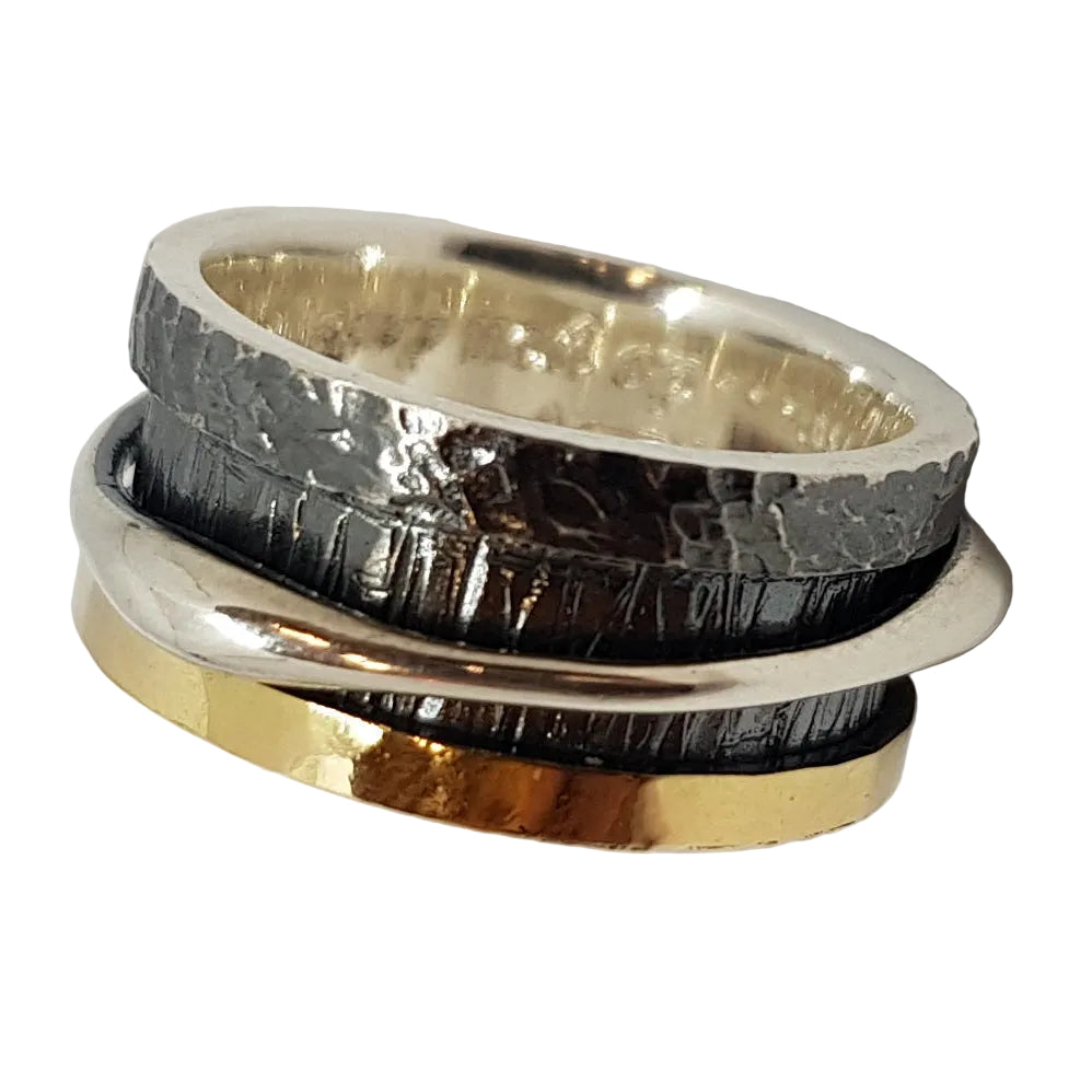 The Spinner Ring in Silver, Oxidised Silver & 18ct Yellow Gold by K.And features three stacked bands: smooth silver, textured oxidised silver, and smooth 18ct gold.