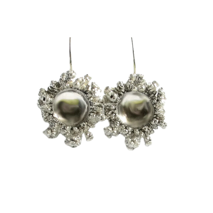 A pair of Spore Drops Silver Earrings by Abbie Dixon shaped like coral reefs. Each earring features a large, spherical silver bead in the center surrounded by an intricate, textured design that resembles coral or a sea creature. These unique electroforming earrings have a hook for wearing.