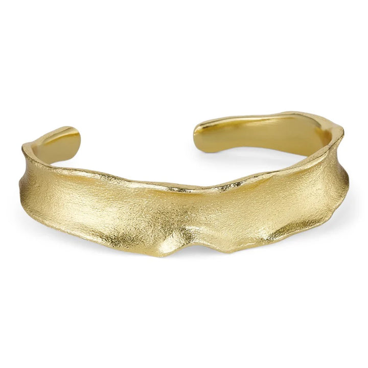 The Statement Bangle by Watermelon tropical is a gold plated brass cuff with a textured, organic, uneven shape and wavy edge, shown on a white background.