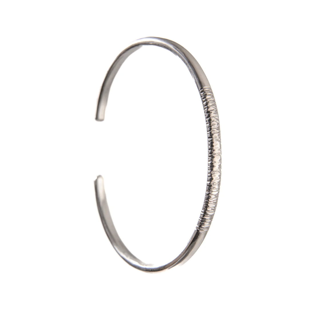 A sterling silver cuff bangle with some bark texture to the front.