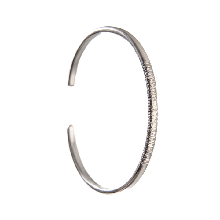 A sterling silver cuff bangle with some bark texture to the front.