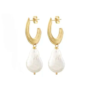 The Strata Thin Earrings with Pearl by Inner island feature gold-toned, textured curves atop large, irregular freshwater pearls; these lightweight earrings bring effortless elegance to any outfit.