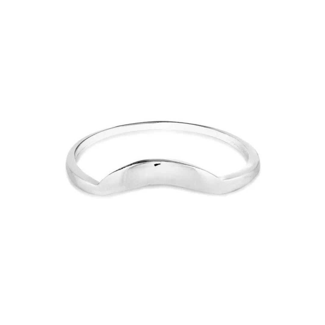 A minimalist Sunrise Ring Silver from Cosmic Boulevard with a sleek, smooth surface featuring a curved, crescent-shaped indent at the front. The ring has a shiny, polished finish and can be elegantly paired with other stacking rings.